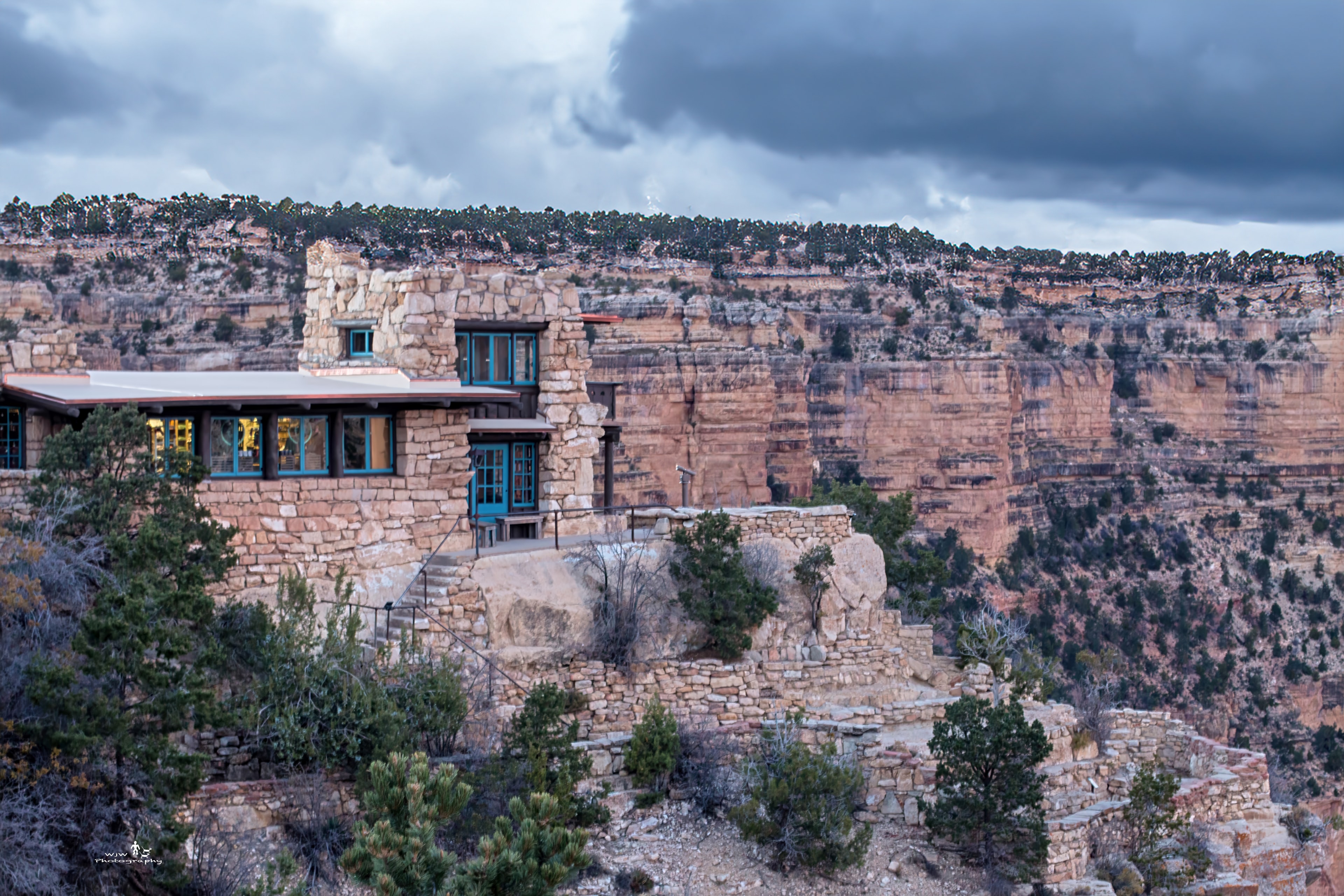 Historic stone building on the South Rim of the Grand Canyon with the vast canyon stretching behind it