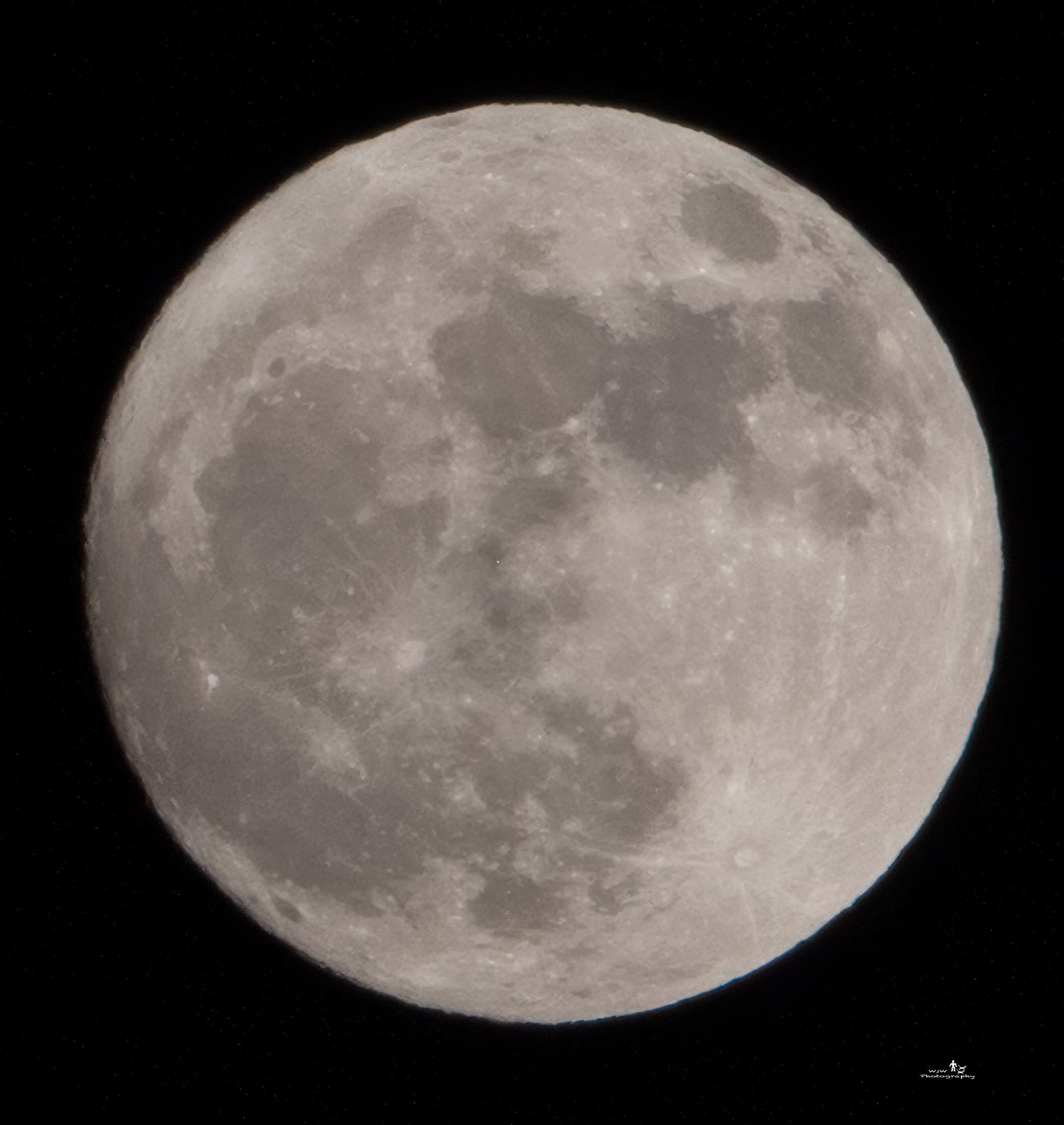 Full moon close-up with detailed crater and mare surface texture against black sky